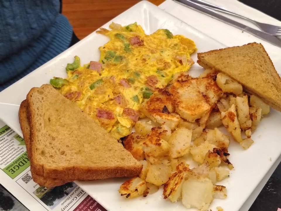 Breakfast menu items beside coffee.